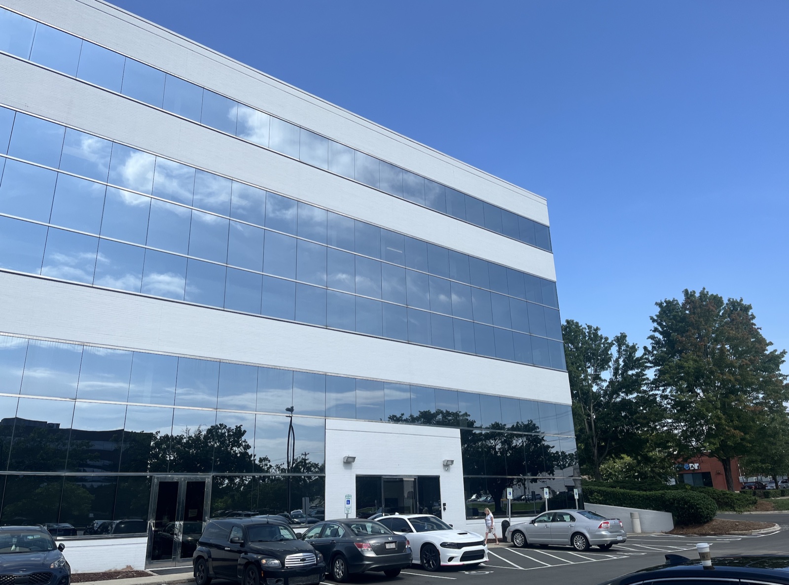 Exterior of the Shoeboxed headquarters office building, a multi-story glass-walled building with reflective windows