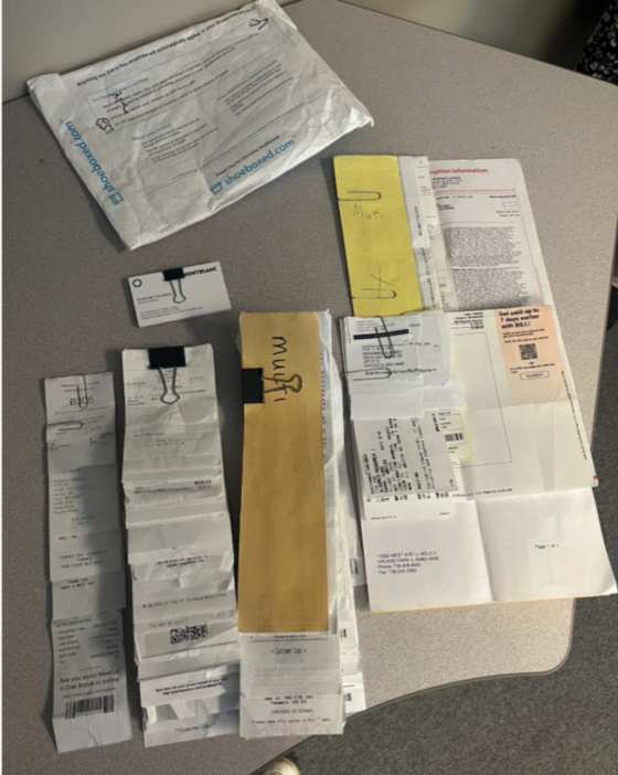 A client's receipts and paperwork laid out next to a Magic Envelope